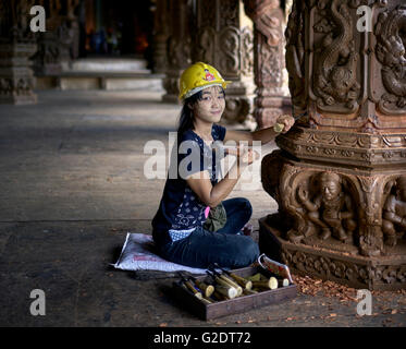 Craftswoman Thailand. Young female builder sculpting and carving wood at the Sanctuary of truth Buddhist Hindu temple. Pattaya Thailand S. E. Asia Stock Photo