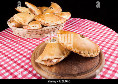 Two Filled pastry on wood plate with full basket in the baskground Stock Photo