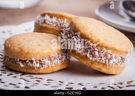 Small round cocnut cookies clos-up on white floral papaer napkin Stock Photo