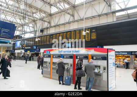 People buying their rail travel tickets at London waterloo railway train station, england Stock Photo