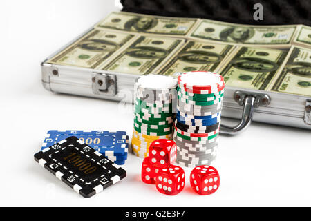 Casino chips with red dice and briefcase full with dollars isolated on white background Stock Photo