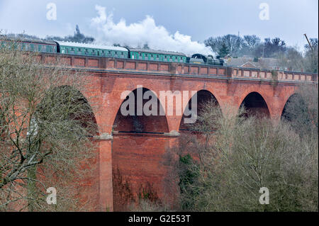 A steam train running on the Imberhorne Viaduct in East Grinstead for the first time since 1958. Stock Photo