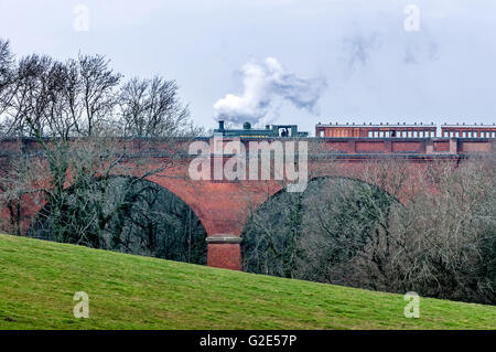 A steam train running on the Imberhorne Viaduct in East Grinstead for the first time since 1958. Stock Photo