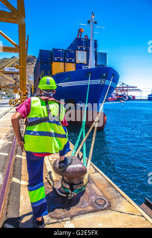 working man mooring a container ship Stock Photo - Alamy