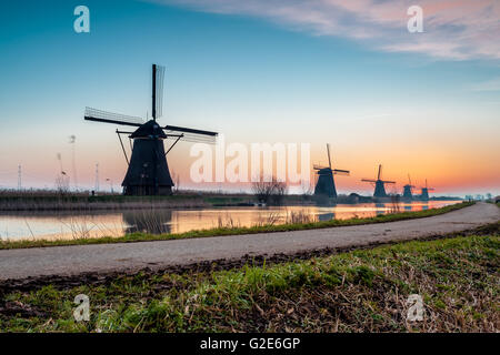 on the water there are several windmills in Kinderdijk in Holland Stock Photo