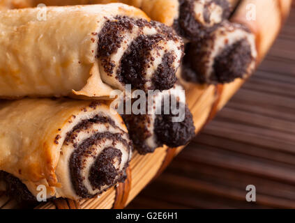 Croissant filled with chocolate closeup on wood background Stock Photo