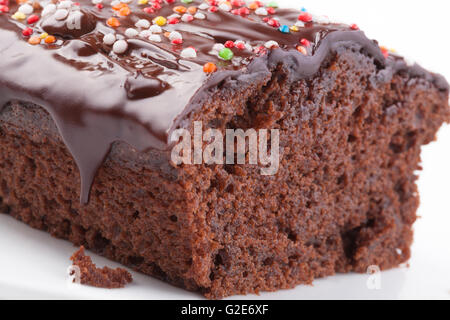 Sweet chocolate cake with colored candy on the top isolated on white Stock Photo