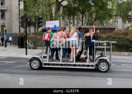 London, UK.  29 May 2016.  A slow moving, environmentally friendly vehicle, running on human pedal-power, passes by the Tower of London holding up traffic.  The capital's new Mayor, Sadiq Khan, has pledged to introduce 'The Ultra Low Emissions Zone (ULEZ)' in an effort to improve London's air quality and reduce pollution caused by vehicle emissions.  Credit:  Stephen Chung / Alamy Live News Stock Photo