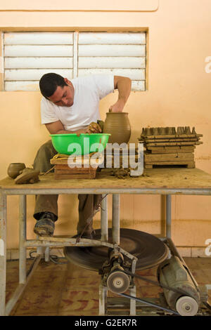 Vertical portrait of a potter sitting at the wheel in Trinidad, Cuba. Stock Photo
