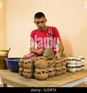 Square portrait of a man decorating pottery in a workshop in Trinidad, Cuba. Stock Photo
