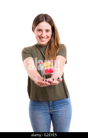 Young woman holding a small cart full of gifts - E-commerce concept Stock Photo