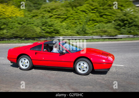 1985 80s red Ferrari 288 GTO, side view in motion; Pendle Power Fest, a classic supercars, veteran sports roadster,  and heritage motor show held at the Nelson & Colne College, Barrowford, Lancashire, UK Stock Photo