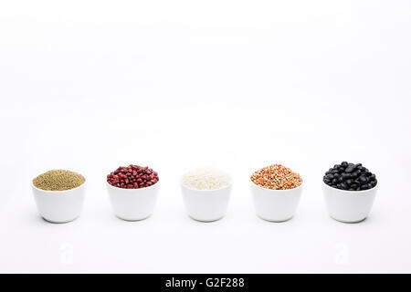 white bowls filled with different types of grain, isolated on white Stock Photo