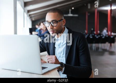 Young handsome businessman working with laptop in the office Stock Photo
