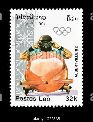 Postage stamp from Laos depicting a bobsled driver, issued for the 1992 WInter Olympic Games, Albertville, France. Stock Photo