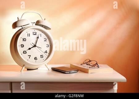 bedside alarm clock and personal belongings in the morning Stock Photo
