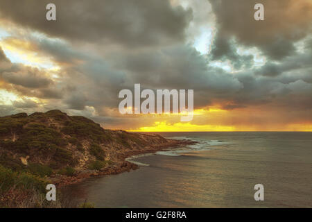 sunset over the surfing beach of Gracetown, Western Australia, Australia, dark storm clouds gathering overhead indicated a storm Stock Photo