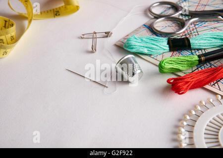 Composition tools for embroidery on white fabric close up.  Horizontal composition. Front elevated view Stock Photo