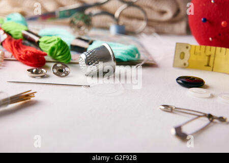 Composition tools for embroidery on white fabric.  Horizontal composition. Front elevated view Stock Photo