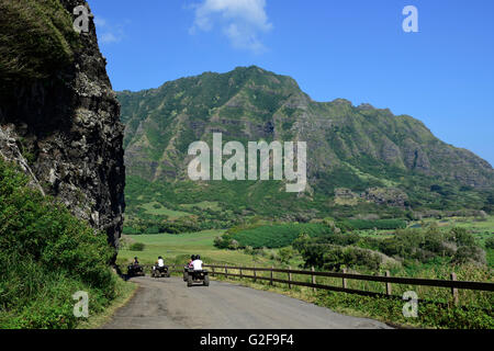 A group of ATV quad riders take to the trail near Ko'olau Range in Oahu, Hawaii. Stock Photo
