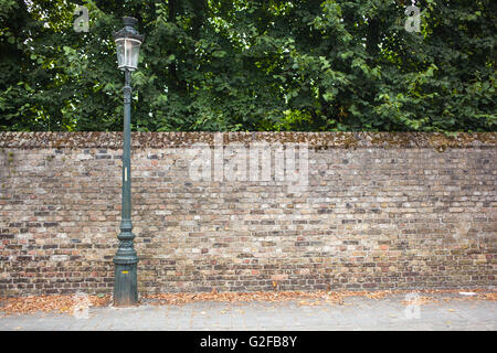 Lamp post street on the left on brick wall background Stock Photo