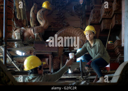 Woman hard hat. Female building site site worker with male counterpart. Sanctuary of Truth (Prasat Sut Ja-Tum) Pattaya Thailand S. E. Asia Stock Photo