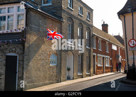 UK street, view of a Union Jack flag hanging from a house in Seckford Street, Woodbridge, Suffolk, England, UK Stock Photo