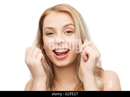 happy young woman with dental floss cleaning teeth Stock Photo