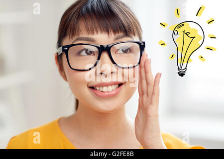 asian woman in glasses with light bulb doodle Stock Photo