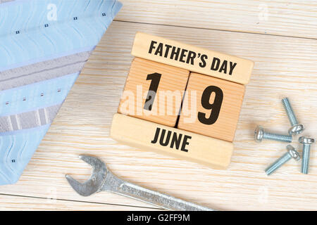 necktie, wooden blocks calendar and spanner greetings card Stock Photo