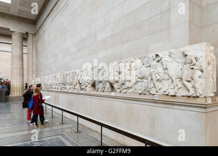 Visitors looking at The Parthenon Sculptures or 'Elgin Marbles', Ancient Greece and Rome Galleries, British Museum, Bloomsbury, London, England, UK Stock Photo