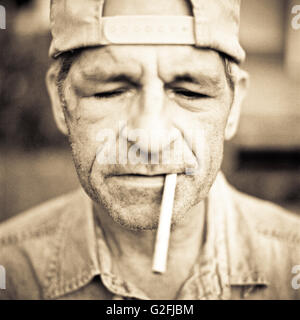 Rugged Man with Cigarette in Mouth Stock Photo