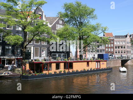 Typical Dutch wooden house boat moored along Prinsengracht canal, Amsterdam, the Netherlands. (opposite Anne Frank House) Stock Photo