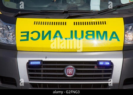 Mirror writing on the front of ambulances, where the word 'AMBULANCE' is written in very large mirrored text, so that drivers see the word the right way around in their rear-view mirror. Fiat Emergency Ambulance at Pendle Power Fest, Barrowford, Lancashire, UK Stock Photo