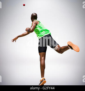 Composite image of rear view of sportsman throwing a shot Stock Photo