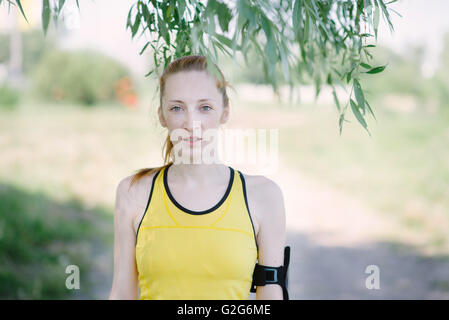 Young woman portrait in sport's clothes. Girl in yellow shirt Stock Photo