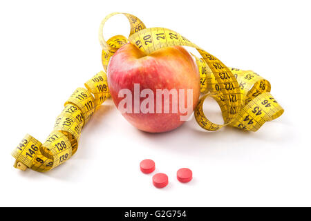 Red Apple with yellow measuring tape and red pills with reflection isolated on white background Stock Photo