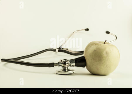 Green ill apple with black stethoscope green type image Stock Photo