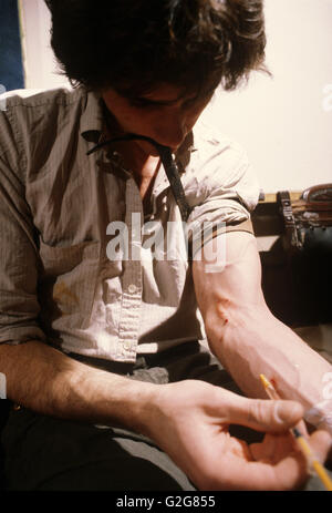 Young man shooting up heroin. Stock Photo