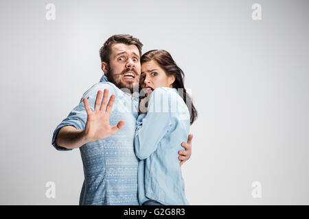 Emotional facial expression wide eyed couple, woman an man looking surprised open mouth Stock Photo