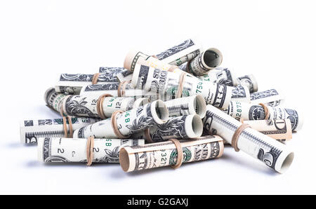 Pile of rolled dollars with elastic band isolaten on white background Stock Photo