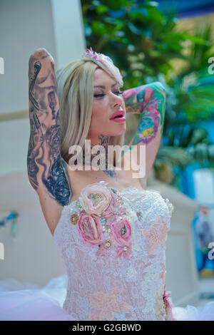 Becky Holt showcasing tattoos and wedding dress by Philippa Lusty at