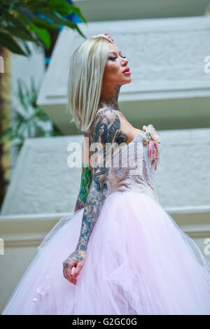 Becky Holt showcasing tattoos and wedding dress by Philippa Lusty at