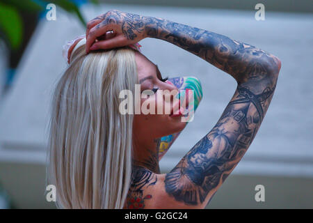 Becky Holt showcasing tattoos and wedding dress by Philippa Lusty at