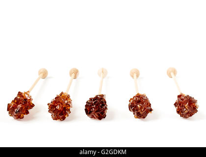 Five brown sugar stirrers isolated on white Stock Photo