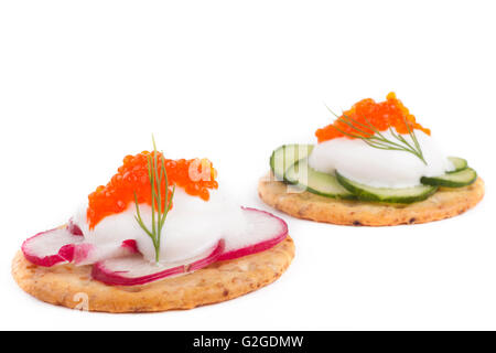 Red caviar on white cheese  appetizer on white background Stock Photo