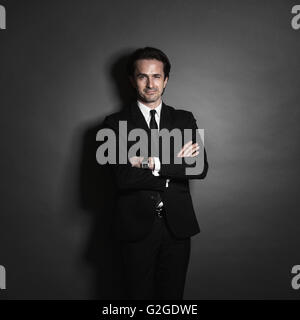 Portrait of businessman in suit on dark background Stock Photo