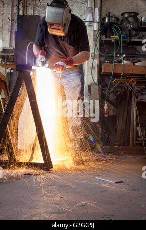 Plasma cutting in a metal workshop with man in action Stock Photo