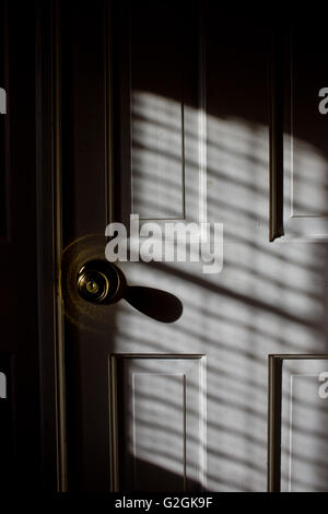 Door and Knob with Shadow, Close-Up Stock Photo