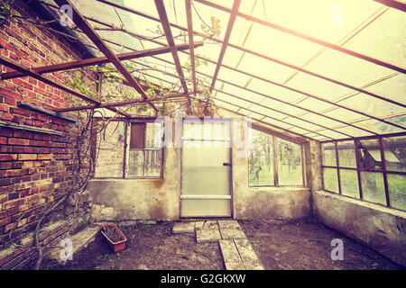Vintage toned wide angle picture of an old empty glasshouse. Stock Photo
